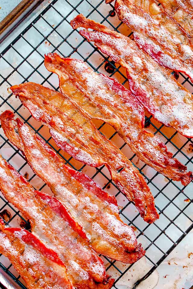 Strips of cooked bacon on a cooling rack.