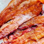 Oven baked bacon on a paper towel.