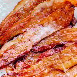Oven baked bacon on a paper towel.