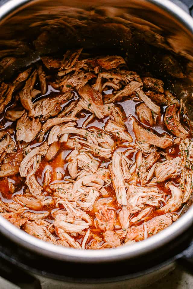 Shredded chicken put back into the honey garlic sauce in the Instant Pot.