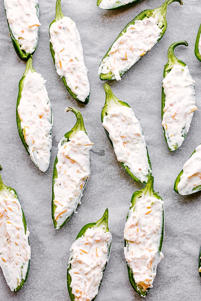 Raw jalapeno halves, stuffed with creamy shredded cheese filling.