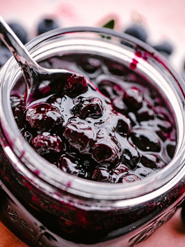 Close up of a jar of homemade blueberry sauce.