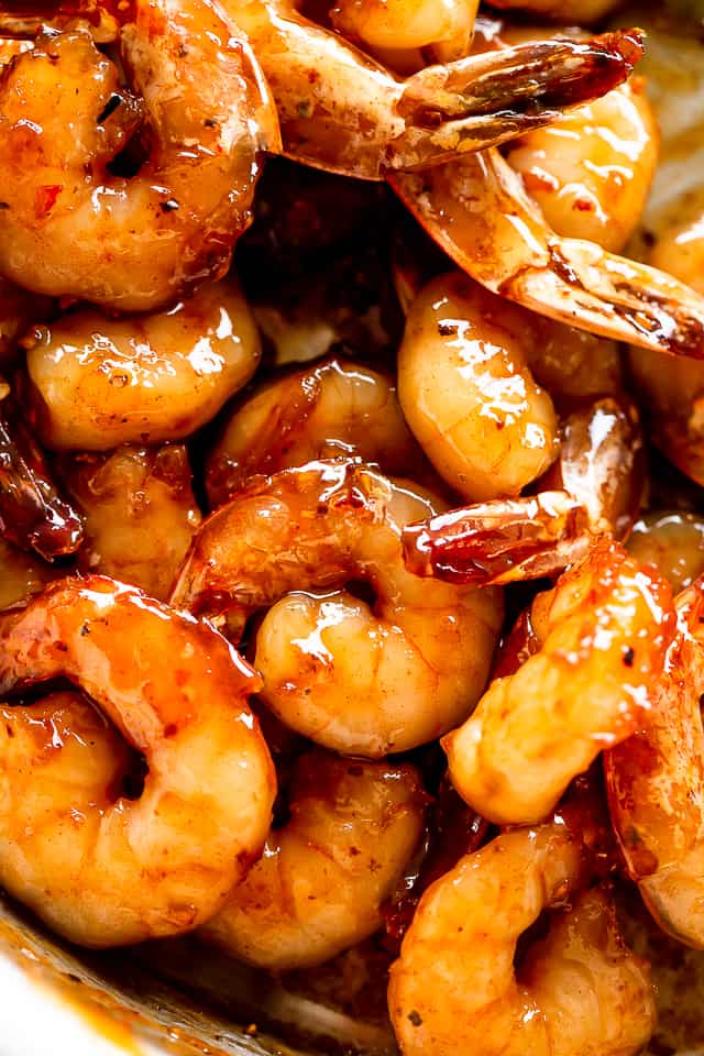 Close-up shot of shrimp cooked in a sticky honey garlic sauce. 