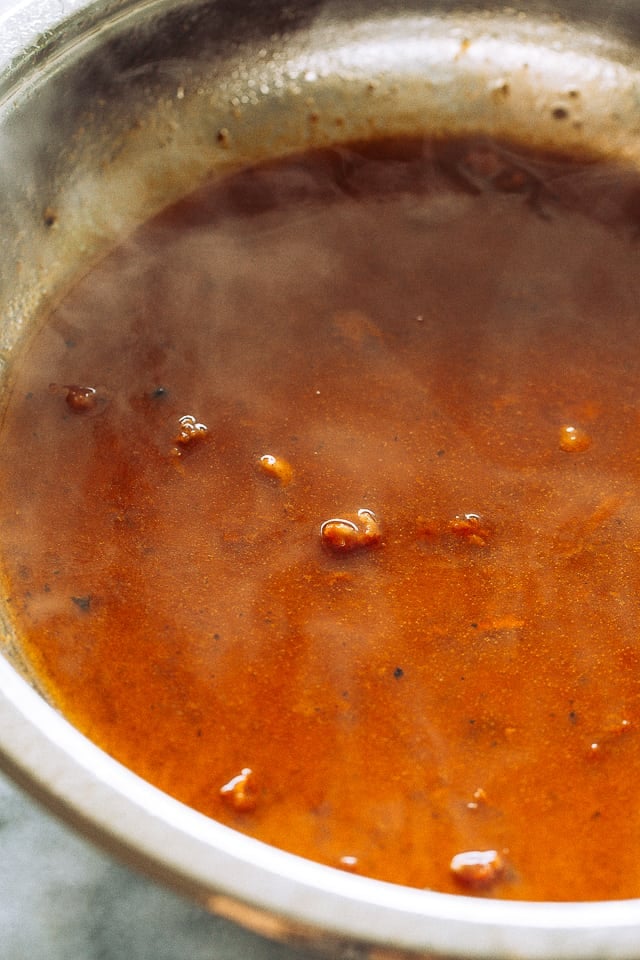 A close-up of simmering pan juices.