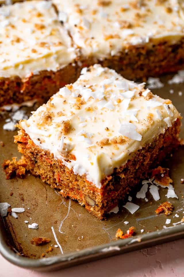 slice of a frosted carrot cake