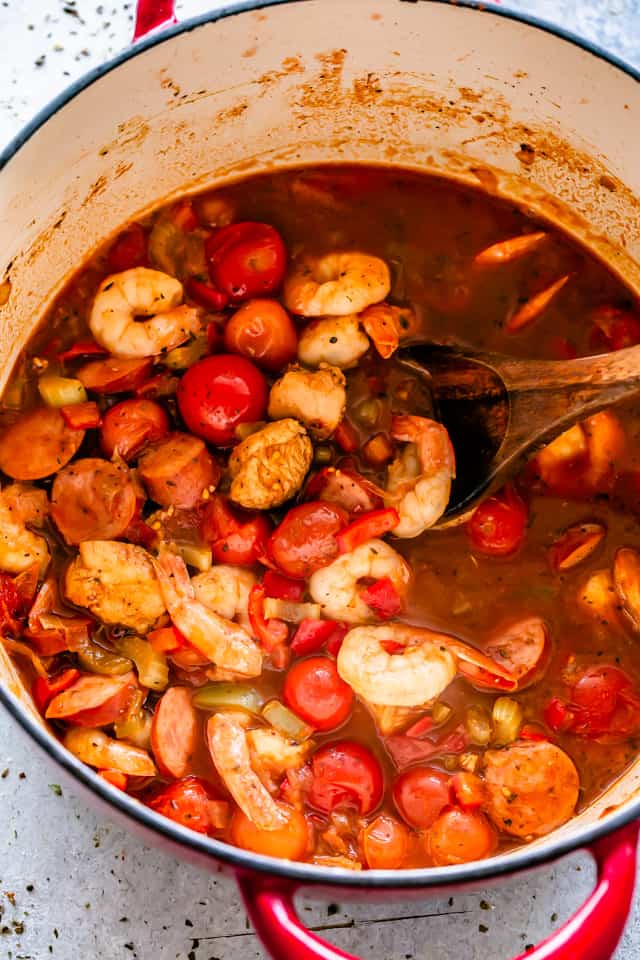 Shrimp, Chicken, and Sausage cook together in a pot