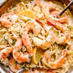 Creamy Shrimp Alfredo Pasta with serving spoons ready to be eaten