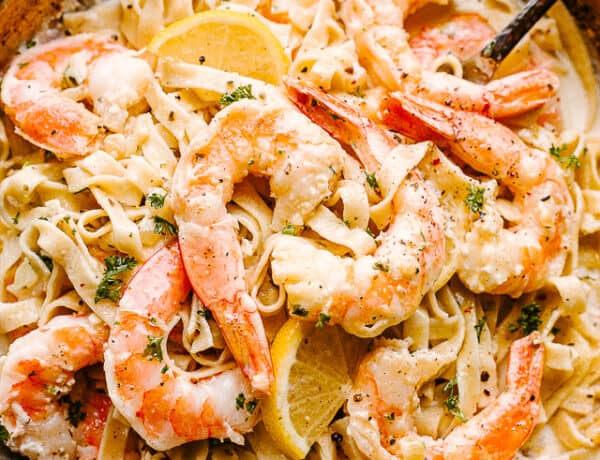 Creamy Shrimp Alfredo Pasta with serving spoons ready to be eaten