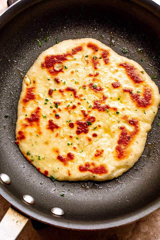 Homemade flatbread cooking in a skillet.