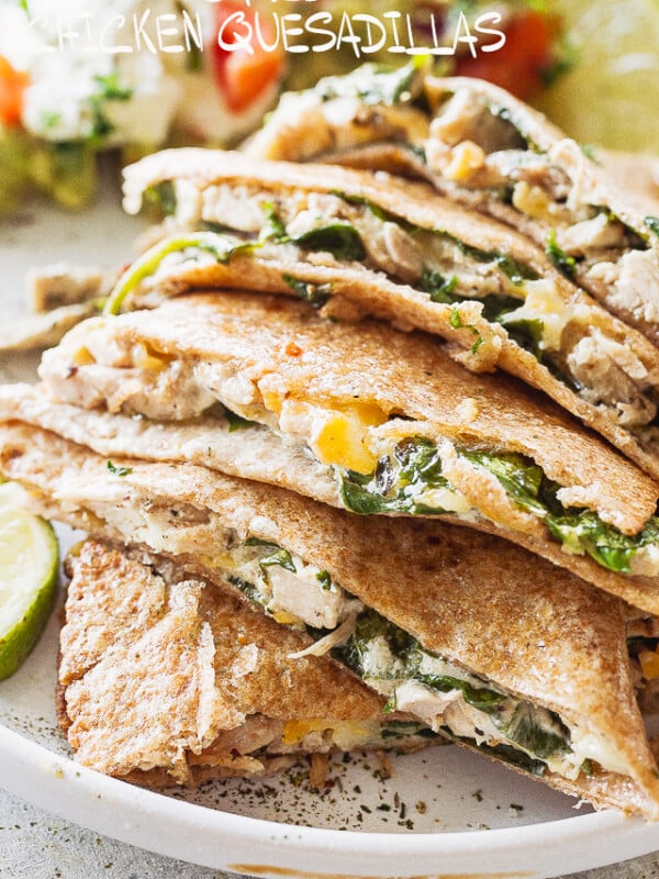 A stack of baked chicken quesadillas on a white plate.