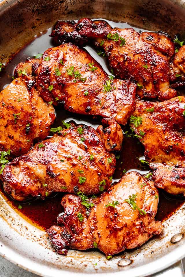 cooking chicken thighs in a skillet 