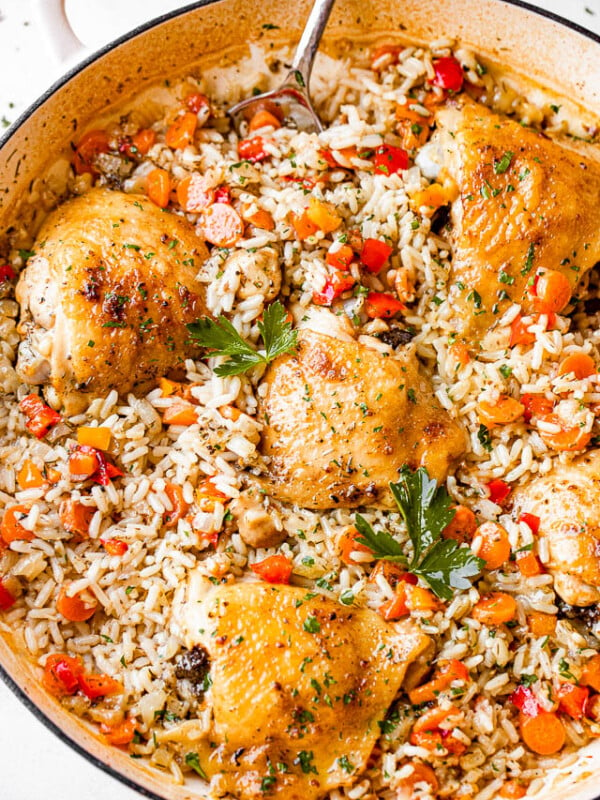 top view of chicken thighs, rice, and vegetables in a pan