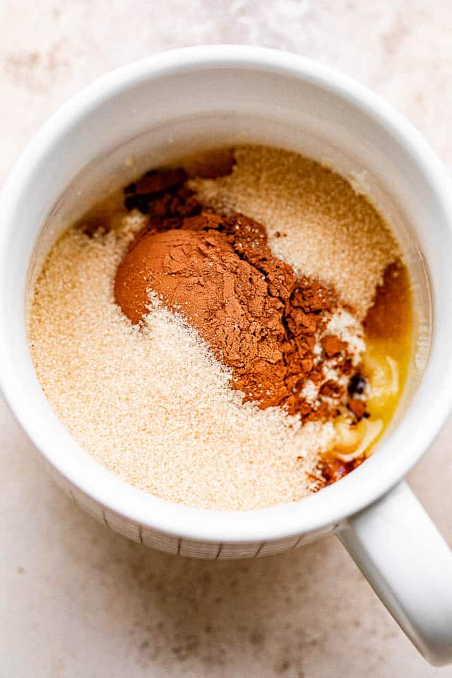 Cocoa powder, flour, and butter in a mug.