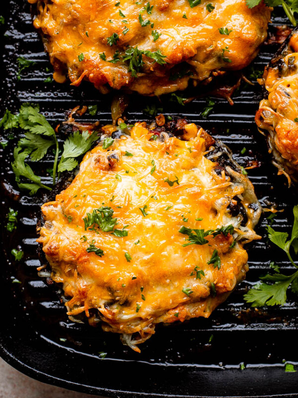 melted cheese over portobella mushrooms on the grill