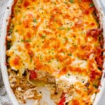 top view of chicken fajita casserole in an oval baking dish topped with melted cheese