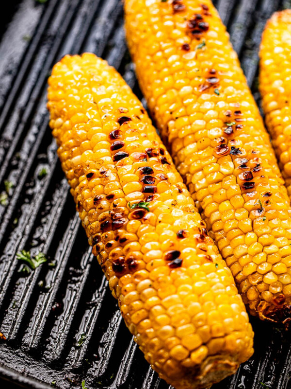 charred cobs of corn on a grill
