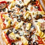 rectangular capricciosa pizza cut into squares