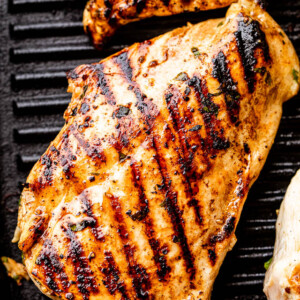 chicken breast with grill marks set on a black grill pan