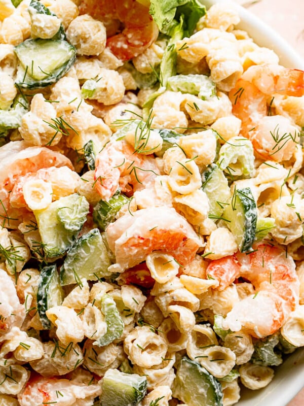 close up top shot of Creamy Shrimp Pasta Salad studded with sliced cucumbers and plump shrimp