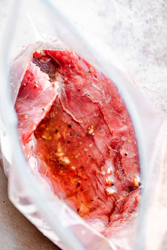 steak in marinade inside ziploc bag