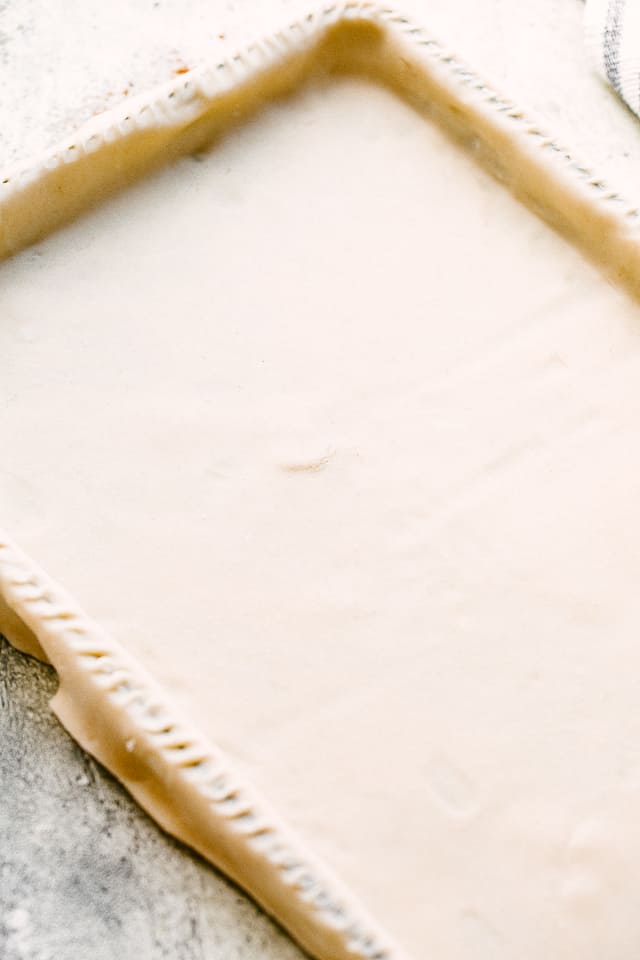 pie dough stretched over a sheet pan.