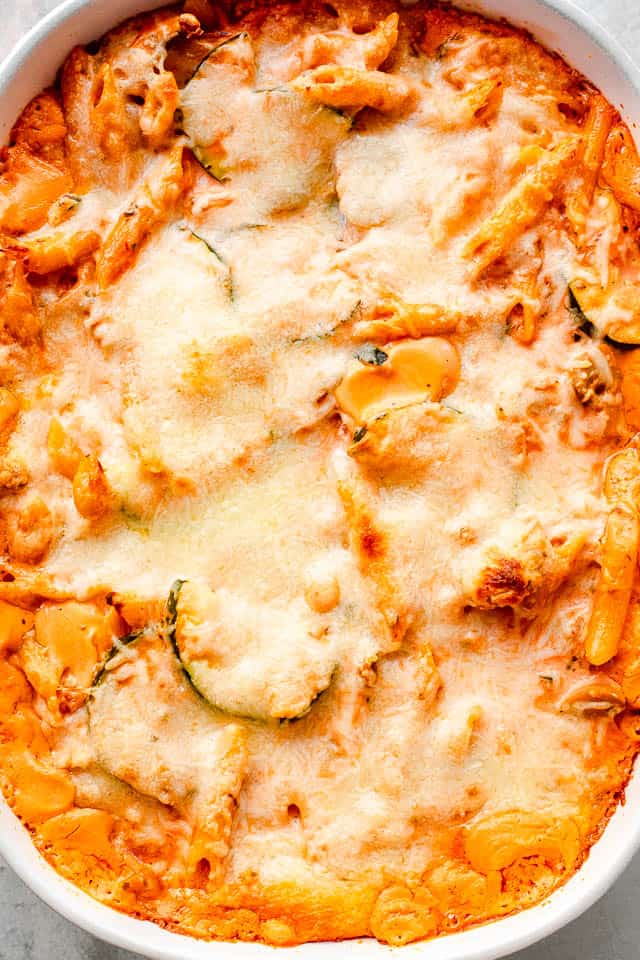 top overhead shot of a cheesy covered baked pasta and zucchini casserole