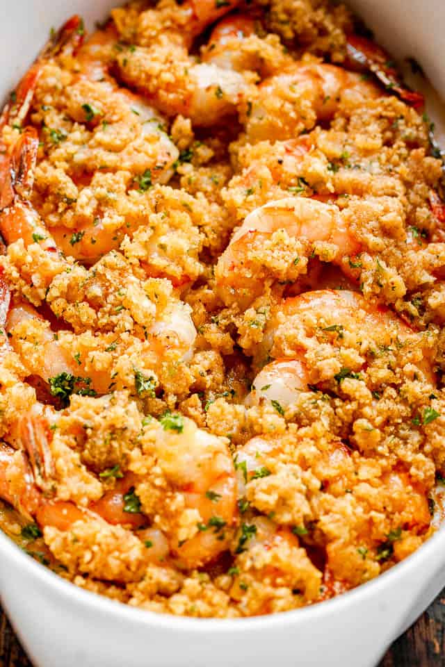 Baked shrimp in a white oval dish.