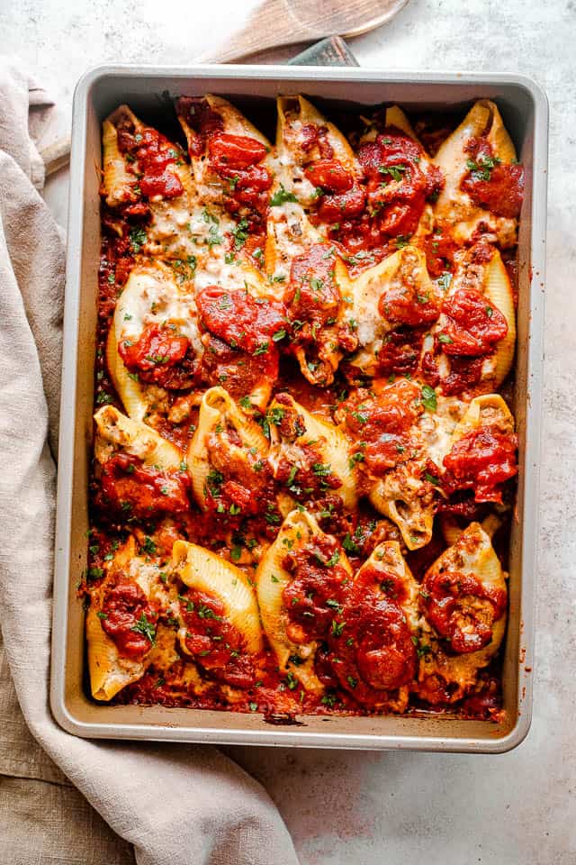 overhead shot of baked pasta shells stuffed with lasagna mixture of beef and cheese.