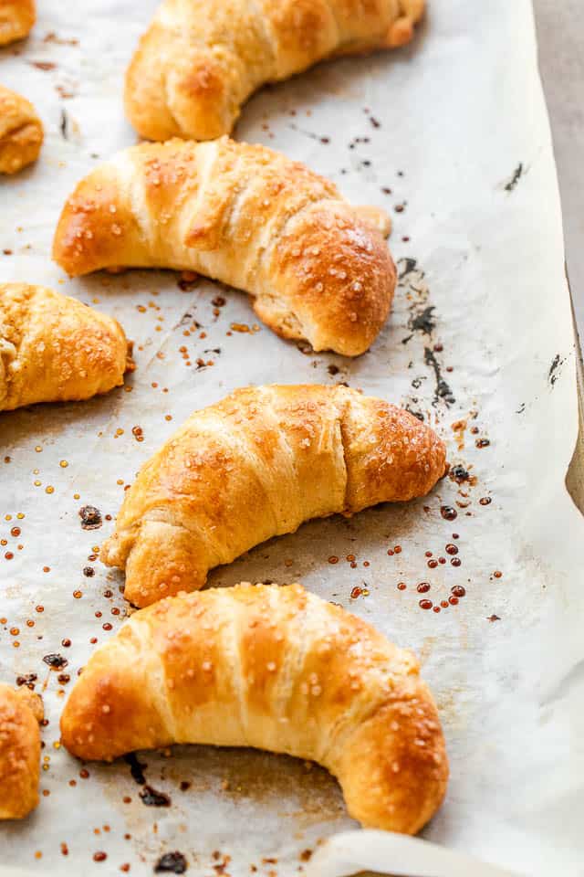 side shot of a baking sheet with baked crescent rolls