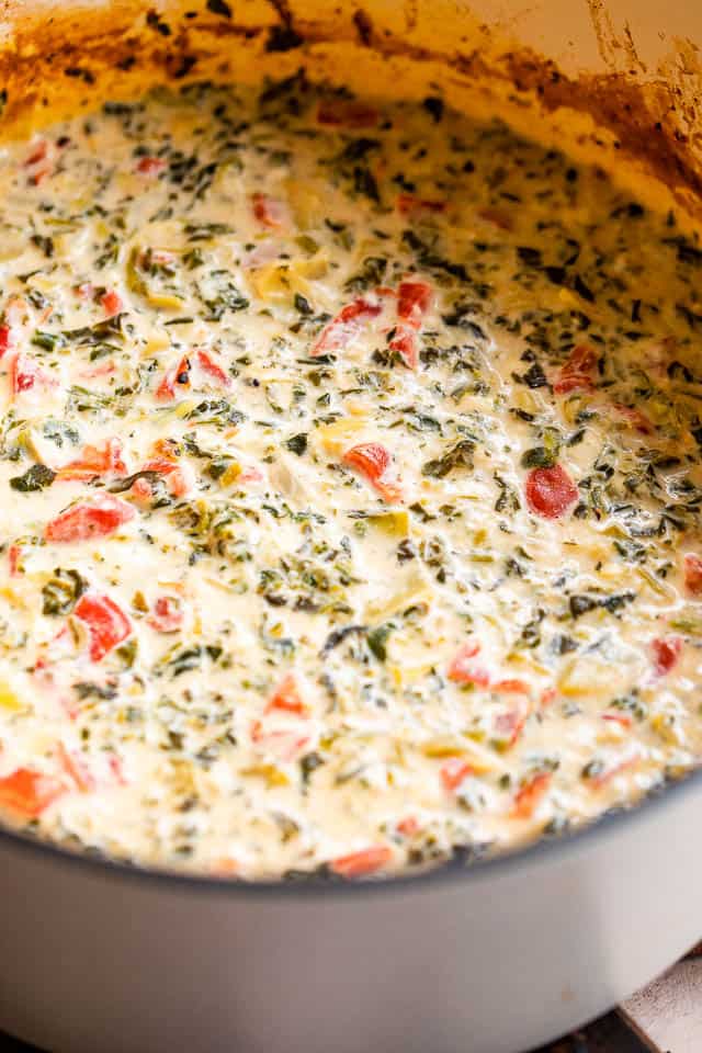 side shot of spinach artichoke dip in slow cooker