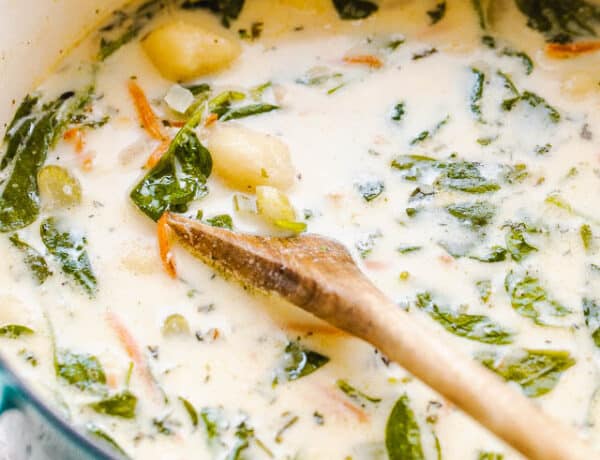 side shot of creamy gnocchi soup with spinach and chicken pictured in dutch oven