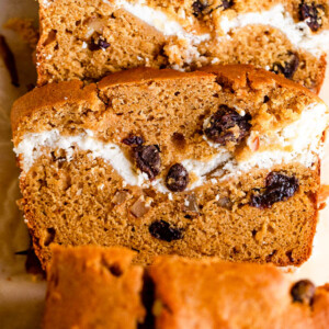 overhead shot of pumpkin bread with a swirl of cream cheese and raisins