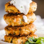 stacked shrimp cakes and topped with sauce