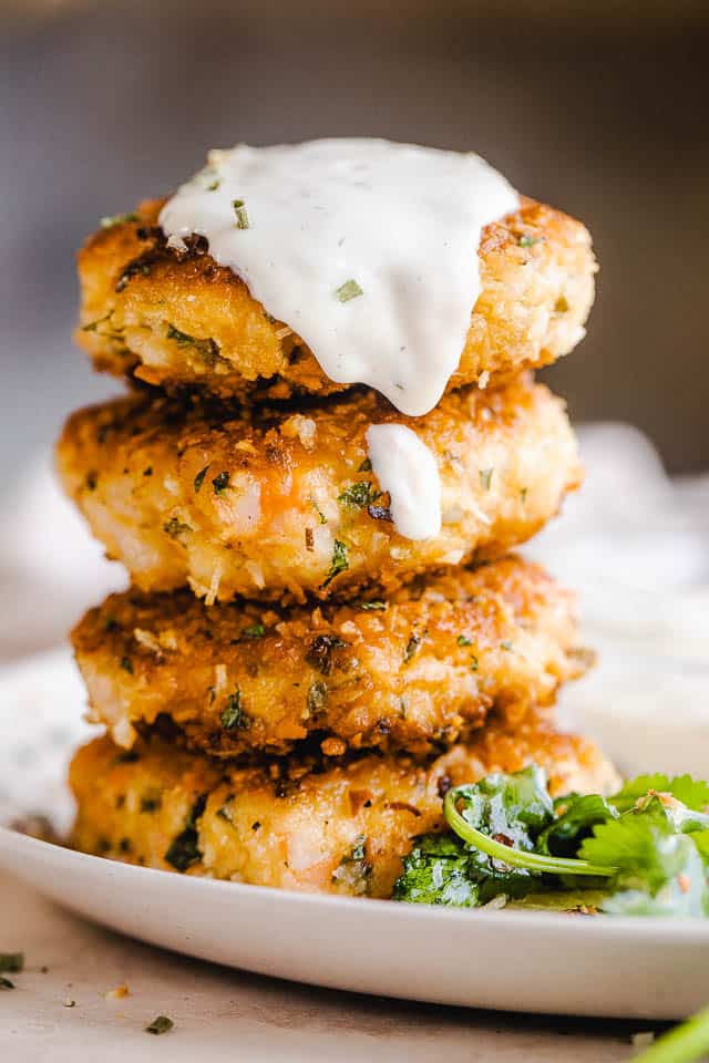stacked shrimp cakes and topped with sauce