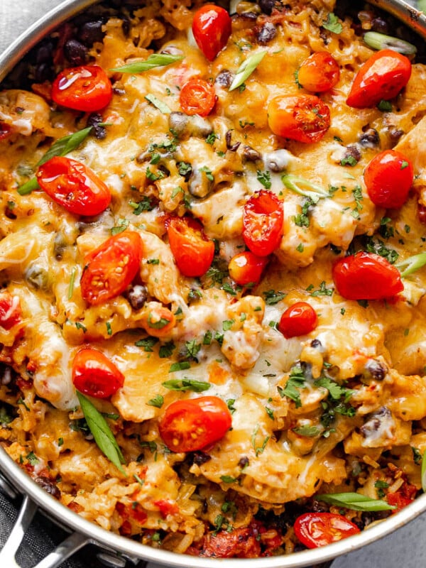 overhead shot of chicken and rice burrito skillet topped with grape tomatoes