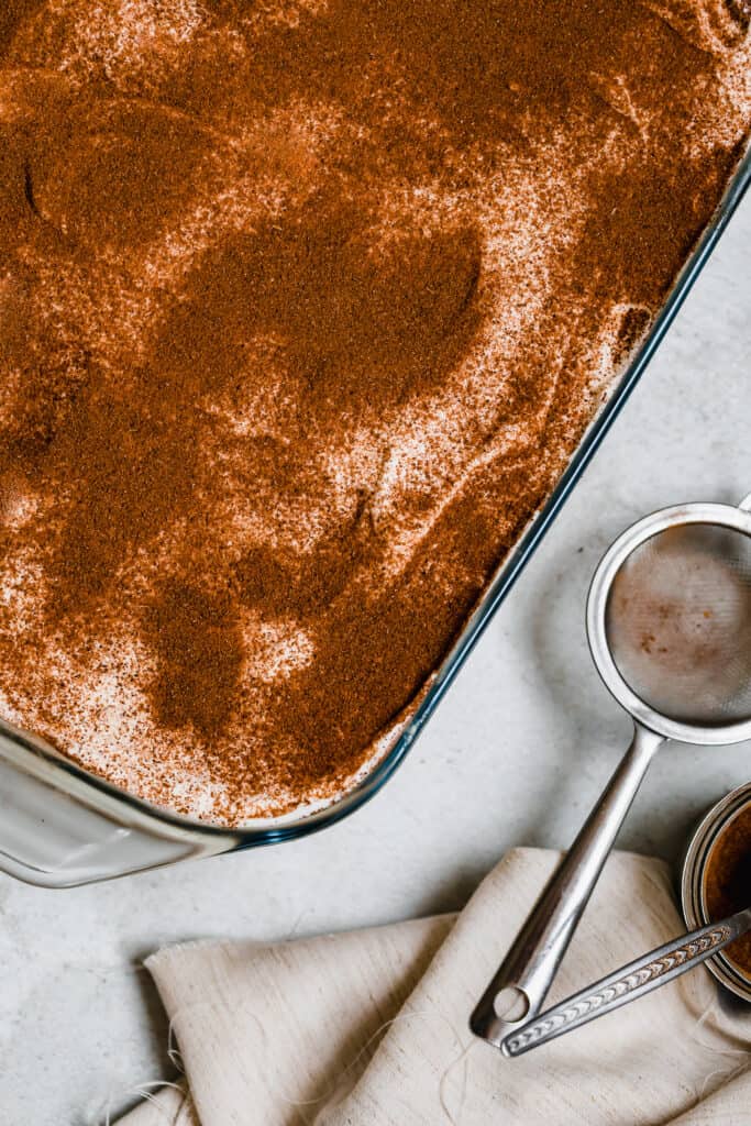 Cinnamon Dusted Over a Tres Leches Cake in a Glass Pan