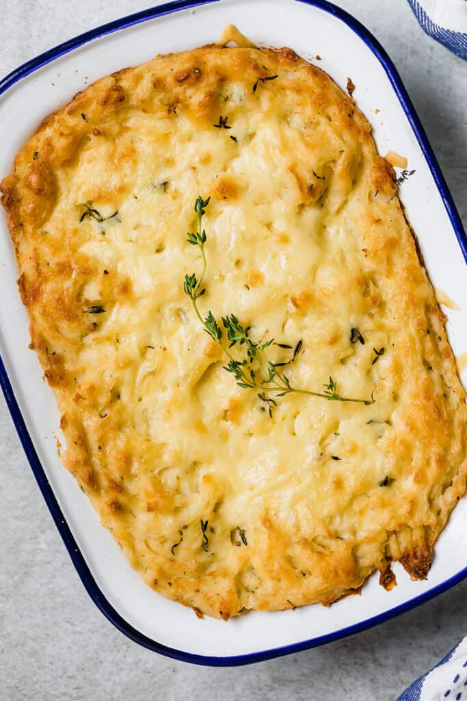 overhead shot of baked mashed potatoes in a white baking dish