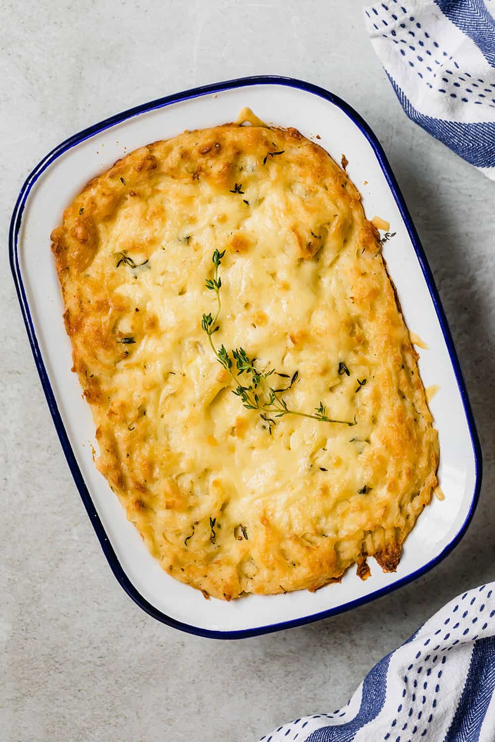 Baked mashed potatoes in a casserole dish.