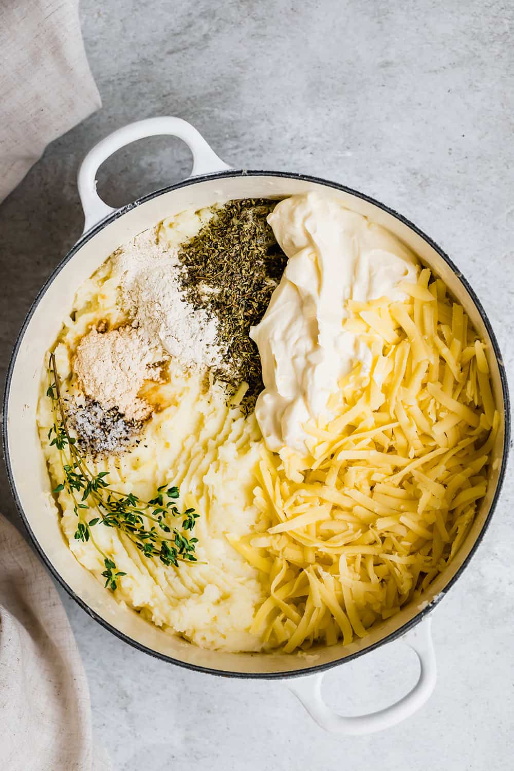 Ingredients for baked mashed potatoes in a pot ready to mix.