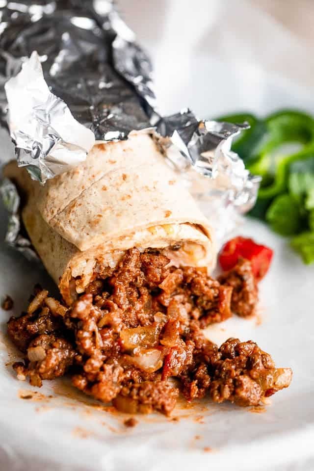 Beef burrito served on a plate.