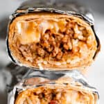 close up shot of two halved burritos stacked one on top of the other