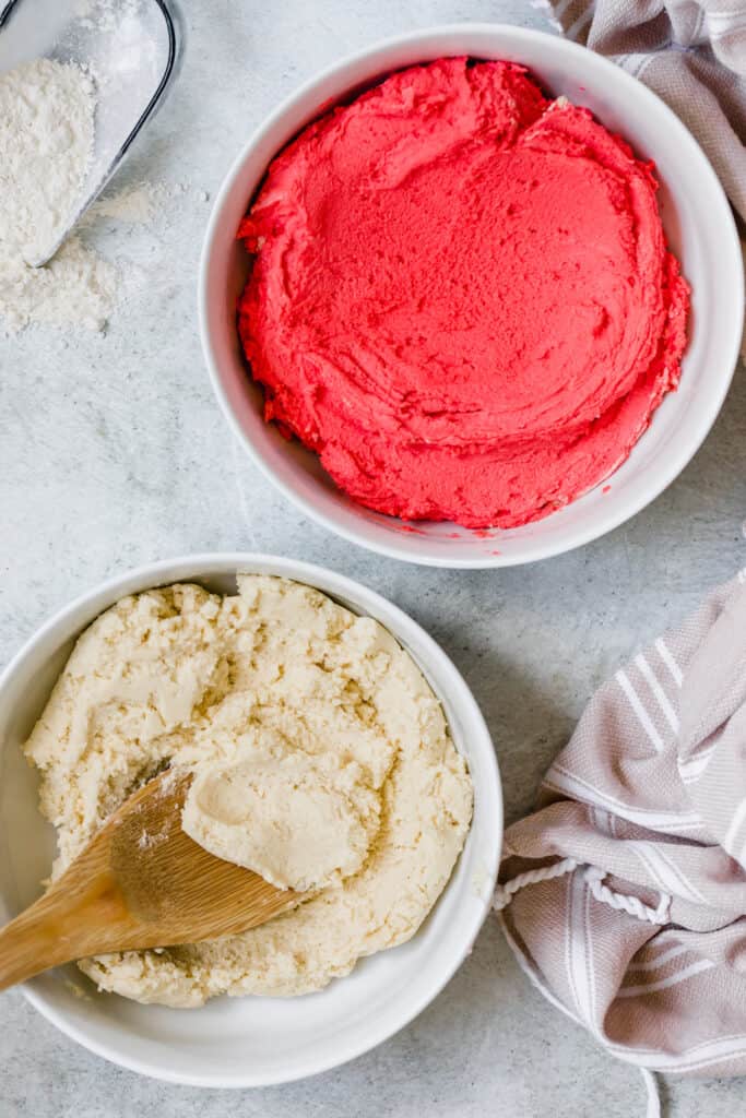 Red and White Candy Cane Cookie Dough in Two Separate White Bowls