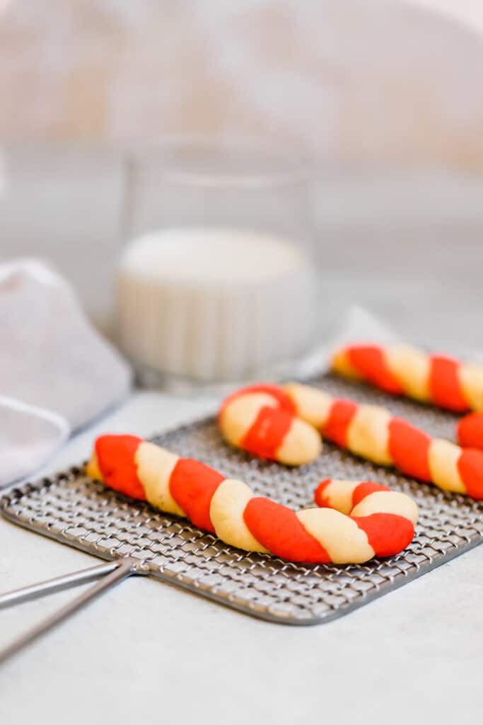 A Line of Three Candy Cane Shaped Cookies Cooling