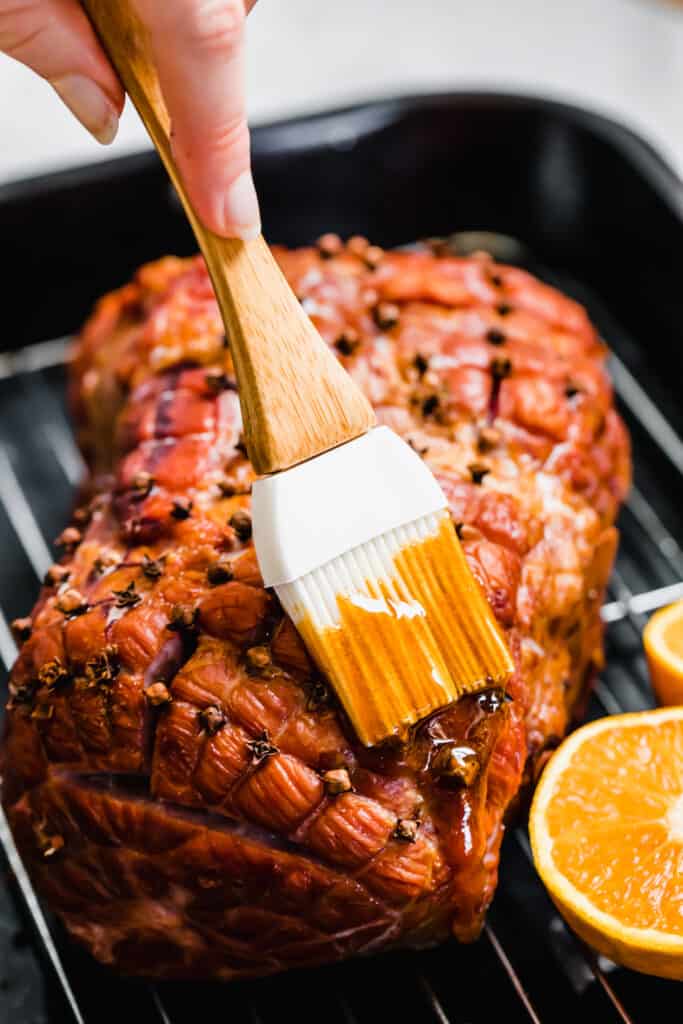 Brushing the Glaze Onto the Ham with a Pastry Brush