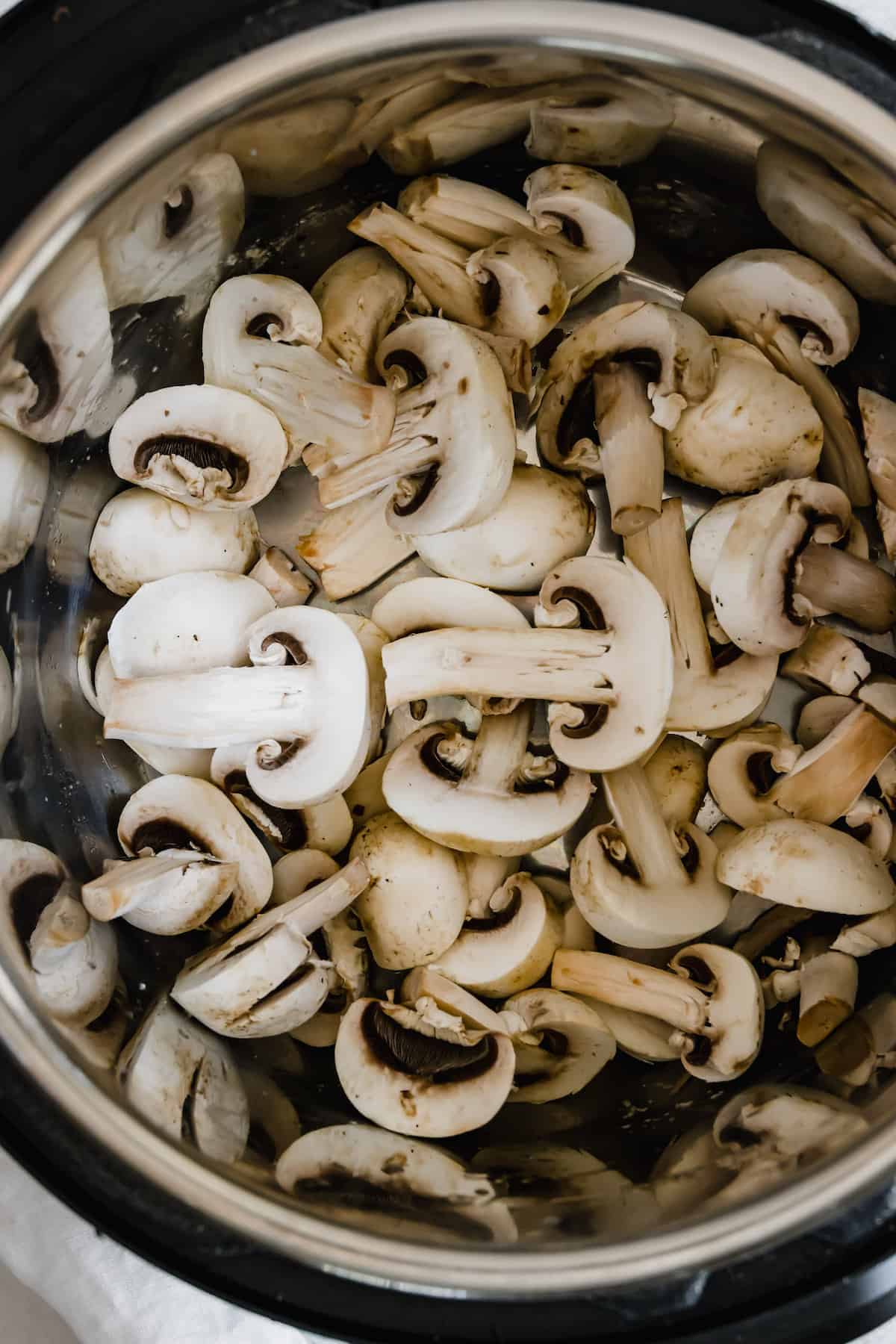 An Instant Pot Bowl Filled with Sliced Mushrooms