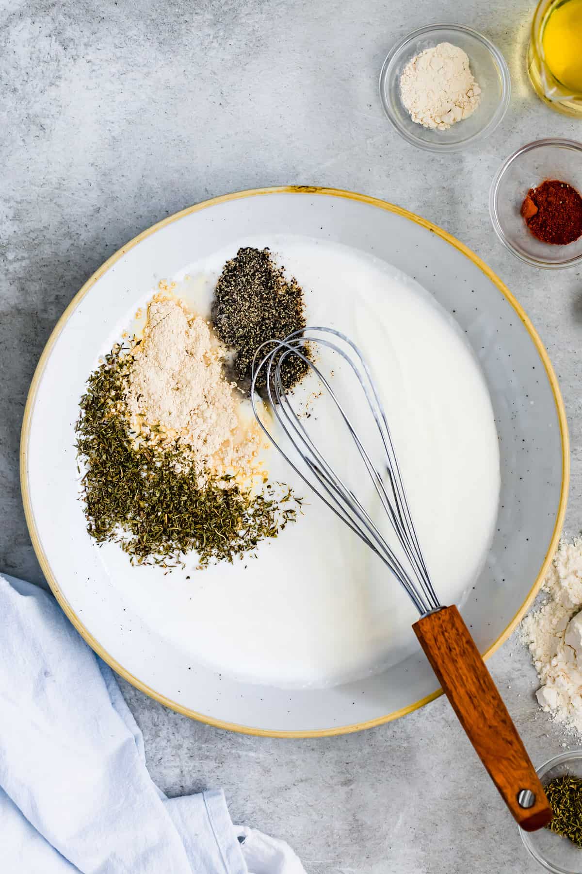 Buttermilk in a Bowl with Garlic Powder, Thyme, Salt and Pepper