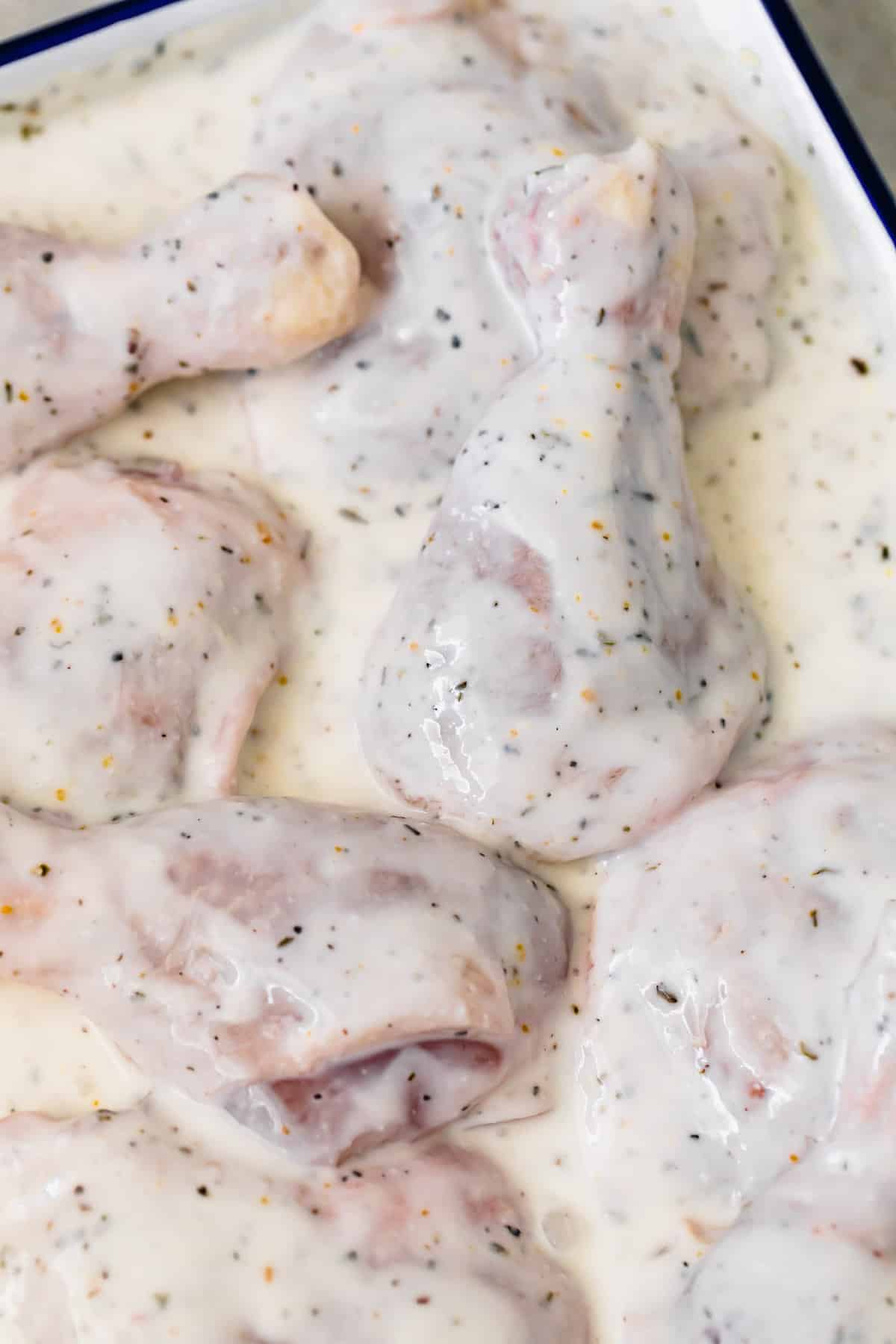 A Pan of Chicken Drumsticks Coated with Spices and Buttermilk