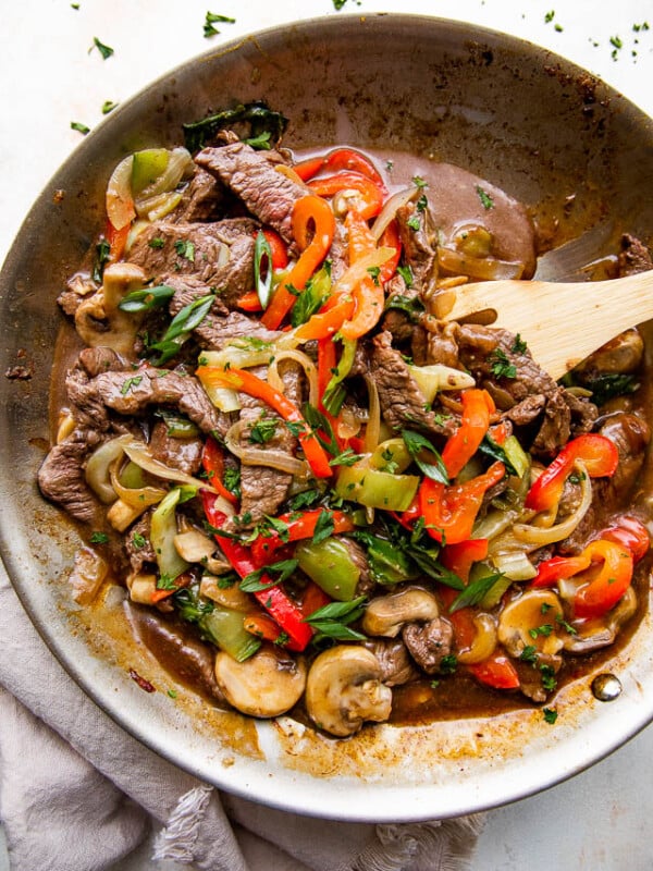 overhead wide shot of a skillet with stir fried beef and vegetables