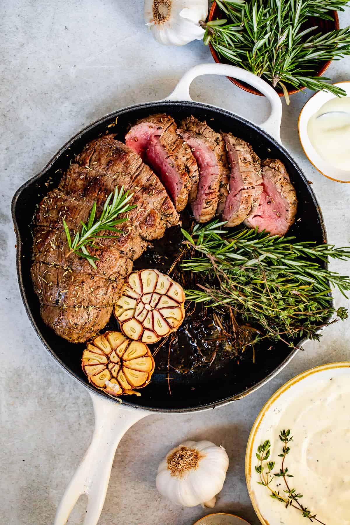 A White Skillet Containing the Cooked Beef and its Garnishes