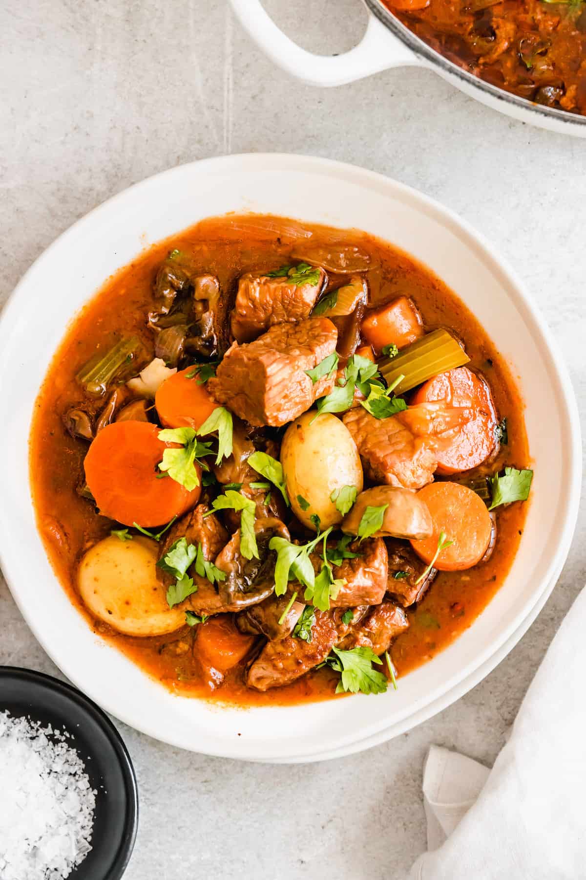 A bowl of beef stew with potatoes and carrots.